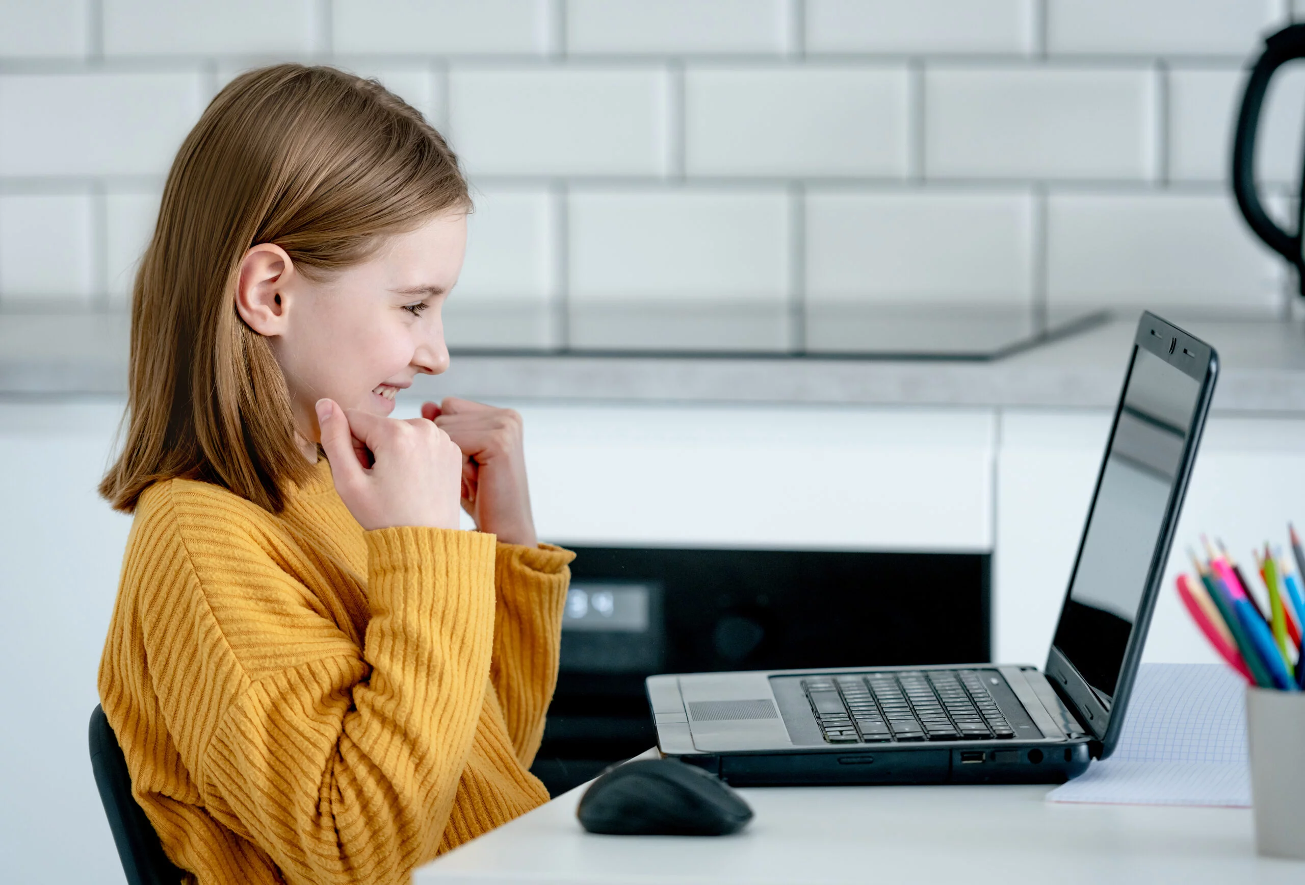 preteen girl with laptop scaled